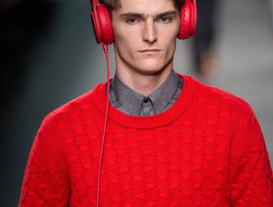sweater clothing apparel sleeve long sleeve person human headphones headset electronics