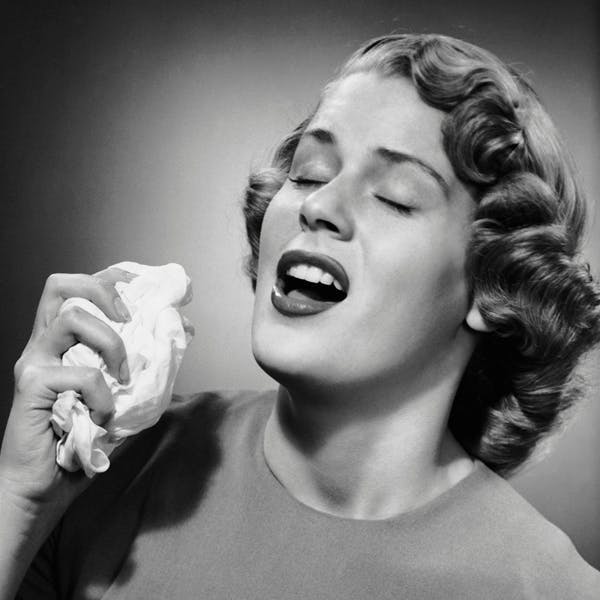 cold expression facial female females health indoor medical science people photodisc sick sneeze tissue vintage woman women retro person human face finger