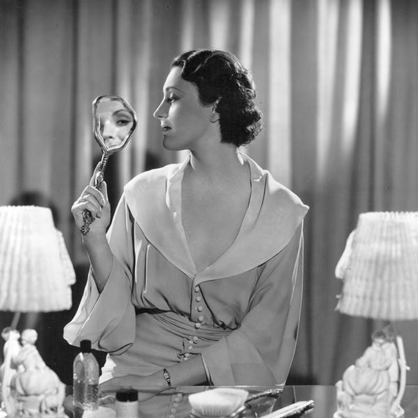 black & white;format portrait;female;reflection;mirror;light;lamp;hair brush;make up;film;film actress;personality;beauty cosmetics;m/cin/port/linaker/kay person human table lamp lamp clothing apparel