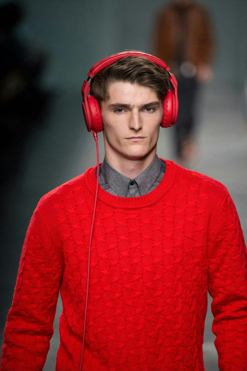 sweater clothing apparel sleeve long sleeve person human headphones headset electronics