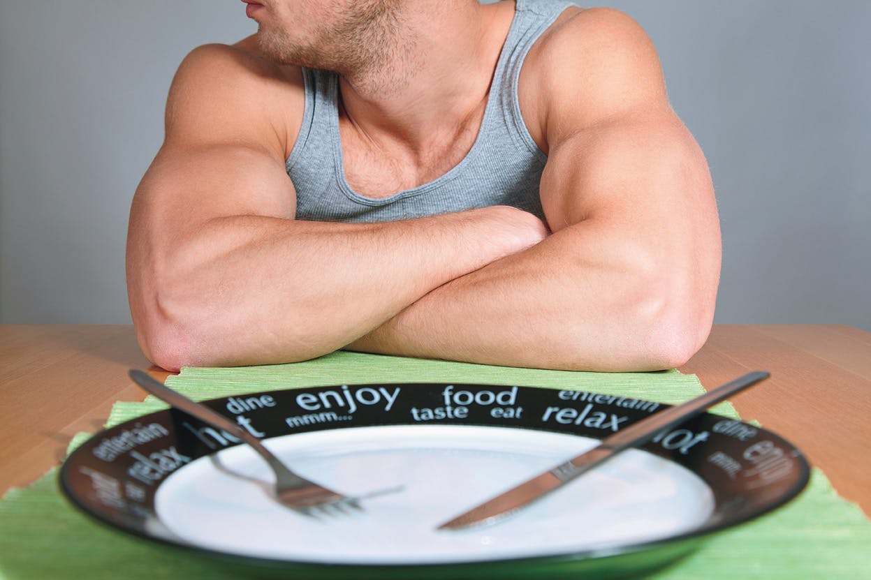 arm breakfast concept diet dieting dining dinner dish dishware eat eating empty food fork hand hungry knife lunch male man meal nutrition people person plate silverware sitting table waiting biceps healthy fit muscle muscular careful big training health slim workout body bodybuilder gym determination resist resistance no choice fitness care human