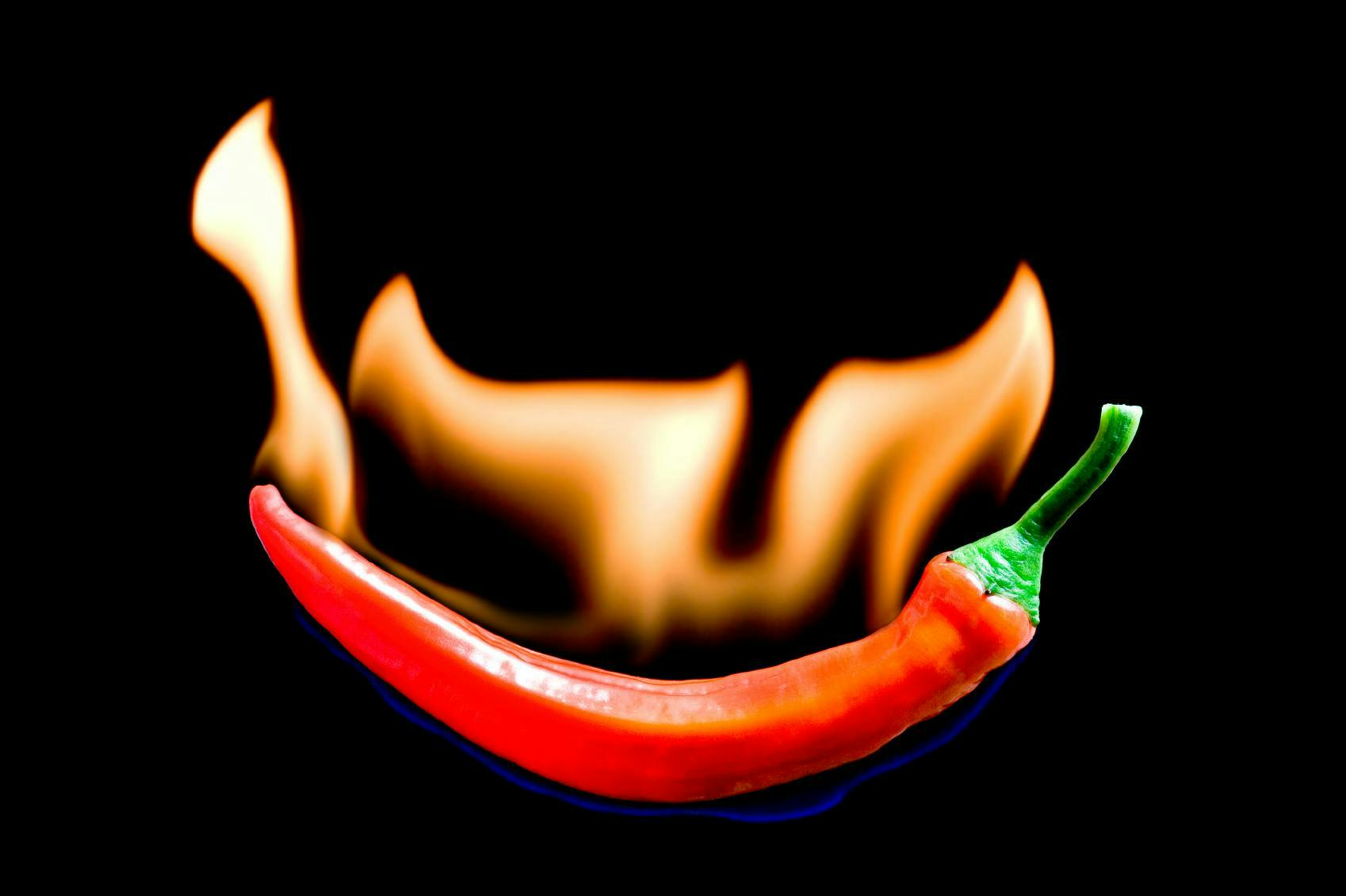 fiery chili pepper hot food spice asian mexican on black red one close up ingredient eating spicy fire frying