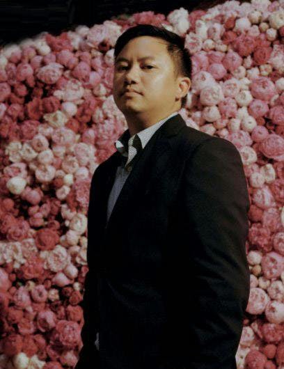 suit clothing overcoat coat apparel petal flower plant person tuxedo