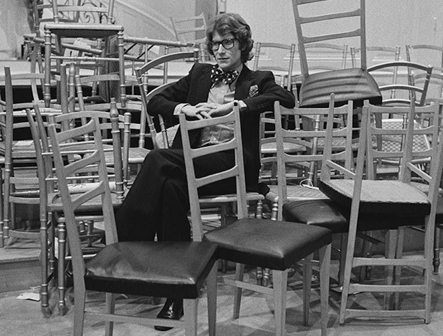 huty19859 huty 19859 black and white 1972 one man exp 1972 382 fr 20-20a huty1985911 indoors full length sitting french fashion designer large group of objects chair hands clasped furniture restaurant person human cafe cafeteria