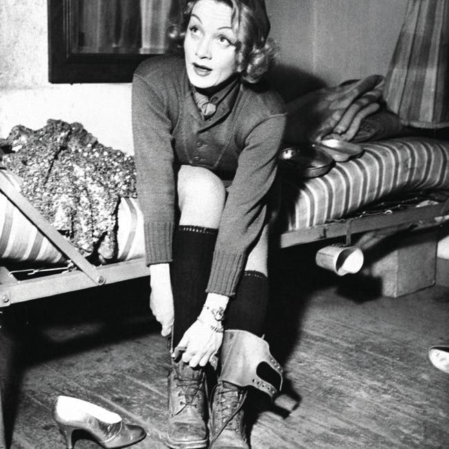 army 40 bed boots bunk cap dietrich don dressing during evening gi gold gown knit long marlene preparing print pumps off onstage sequined she perform sitting sporting sweater takes show underwear undressing uso vintage while wool actress us 244914 timeincown clothing apparel footwear person human couch furniture shoe